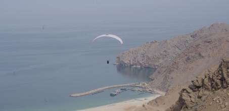 Paragliding into Zighy Bay