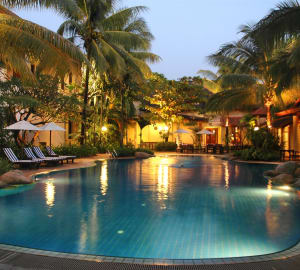 Swimming pool lit up at night - Settha Palace Hotel