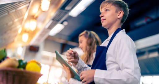 Teen in professional kitchen 