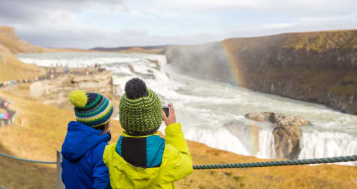 Children taking a photo of hte waterfalls 