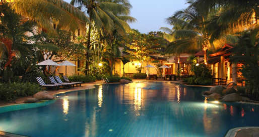 Swimming pool lit up at night - Settha Palace Hotel