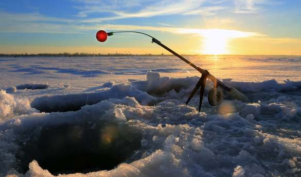 Ice fishing by snowmobile sleigh
