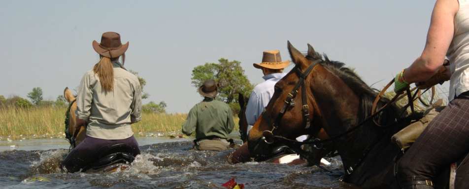 Riding through a river - Macatoo Camp