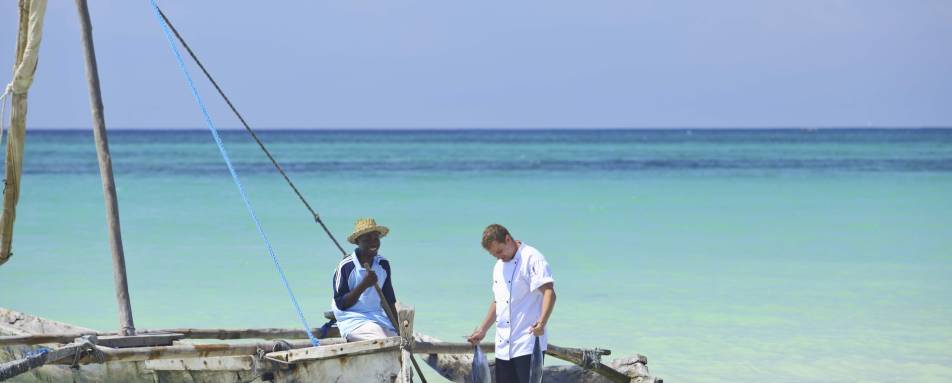 Chef and fisherman on beach 