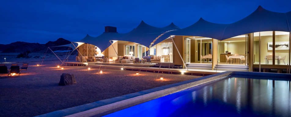 Camp and swimming pool at night   