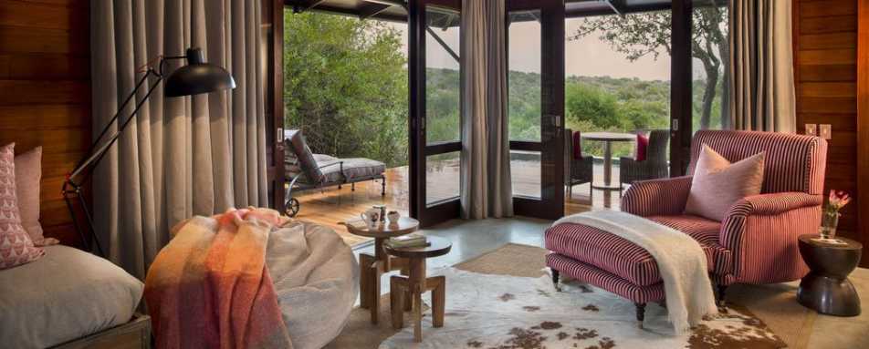 The lounge in a red suite - Kwandwe Ecca Lodge