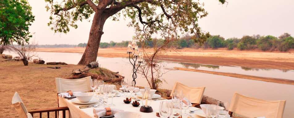 Dinner by the river - Mchenja Bush Camp