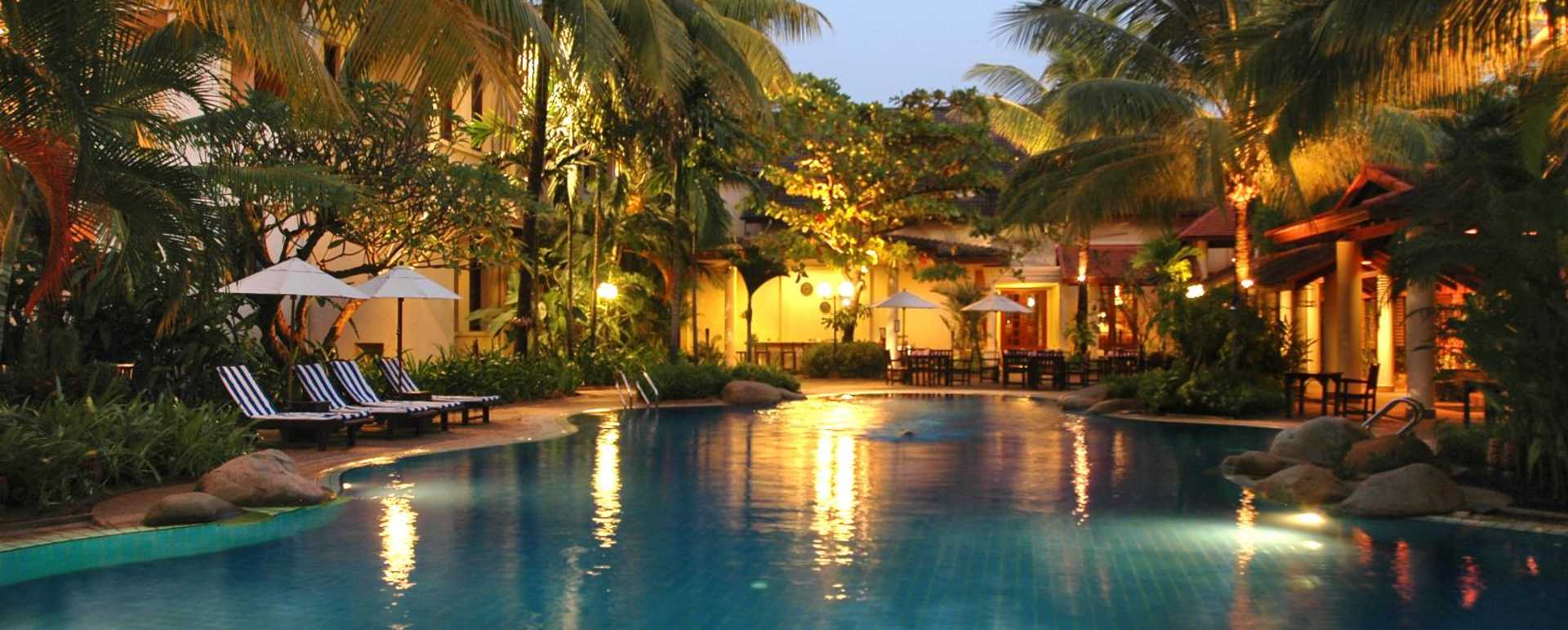 Swimming pool lit up at night - Settha Palace Hotel