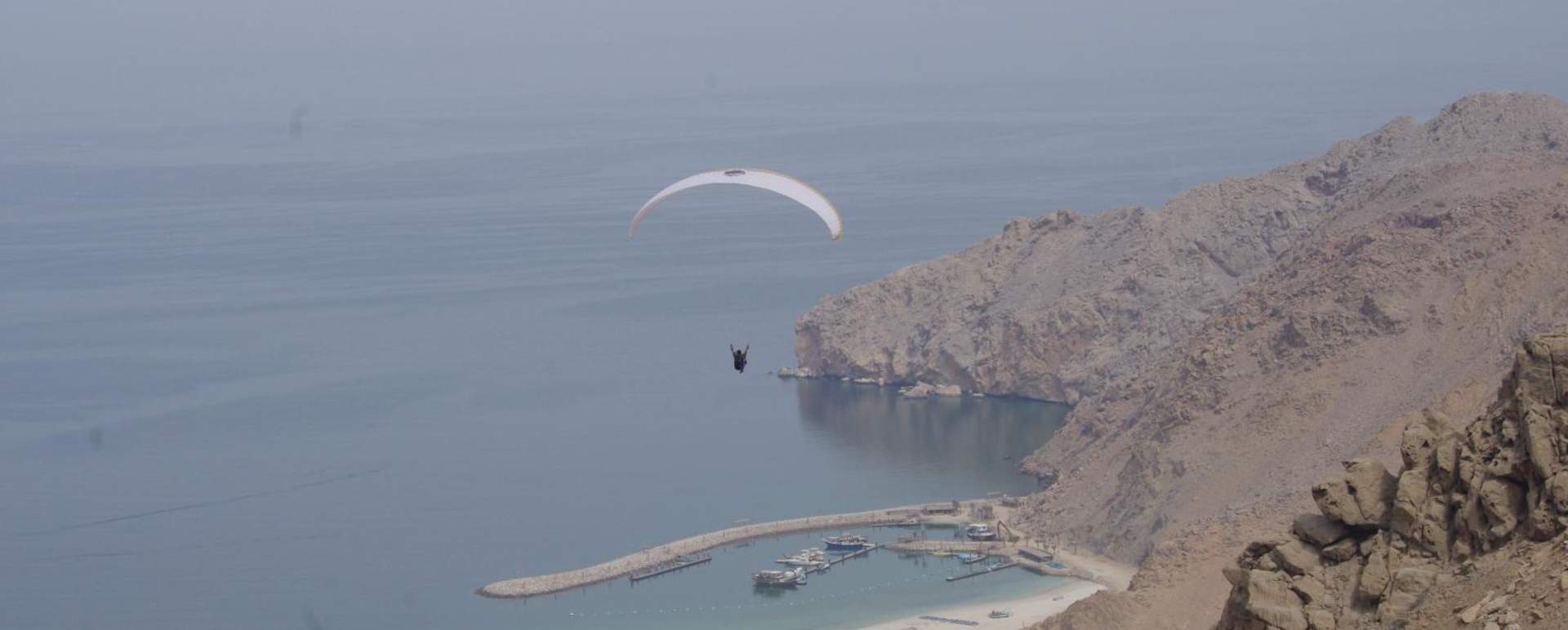 Paragliding into Zighy Bay