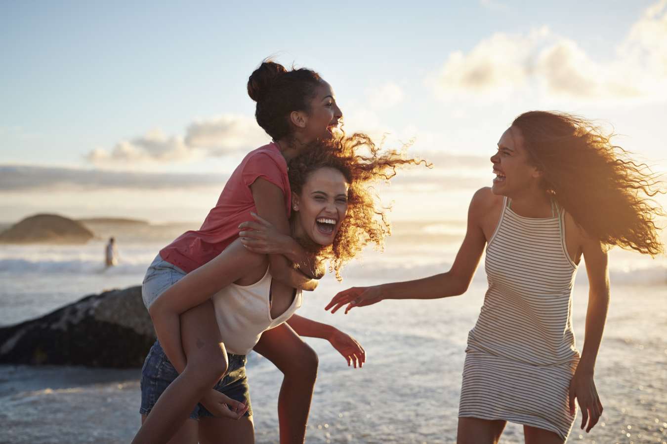 Teen girls playing on beach