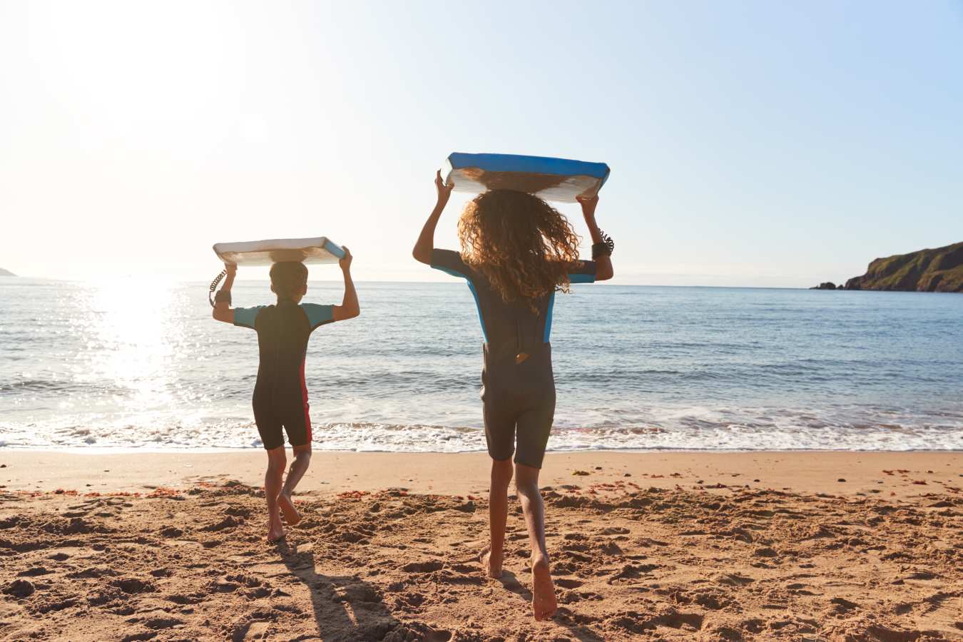 Kids with body boards on beach