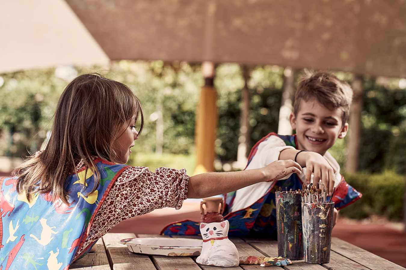 Children painting and smiling