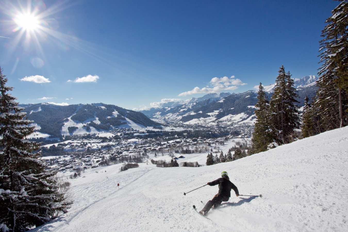 Skier and view of Megeve village