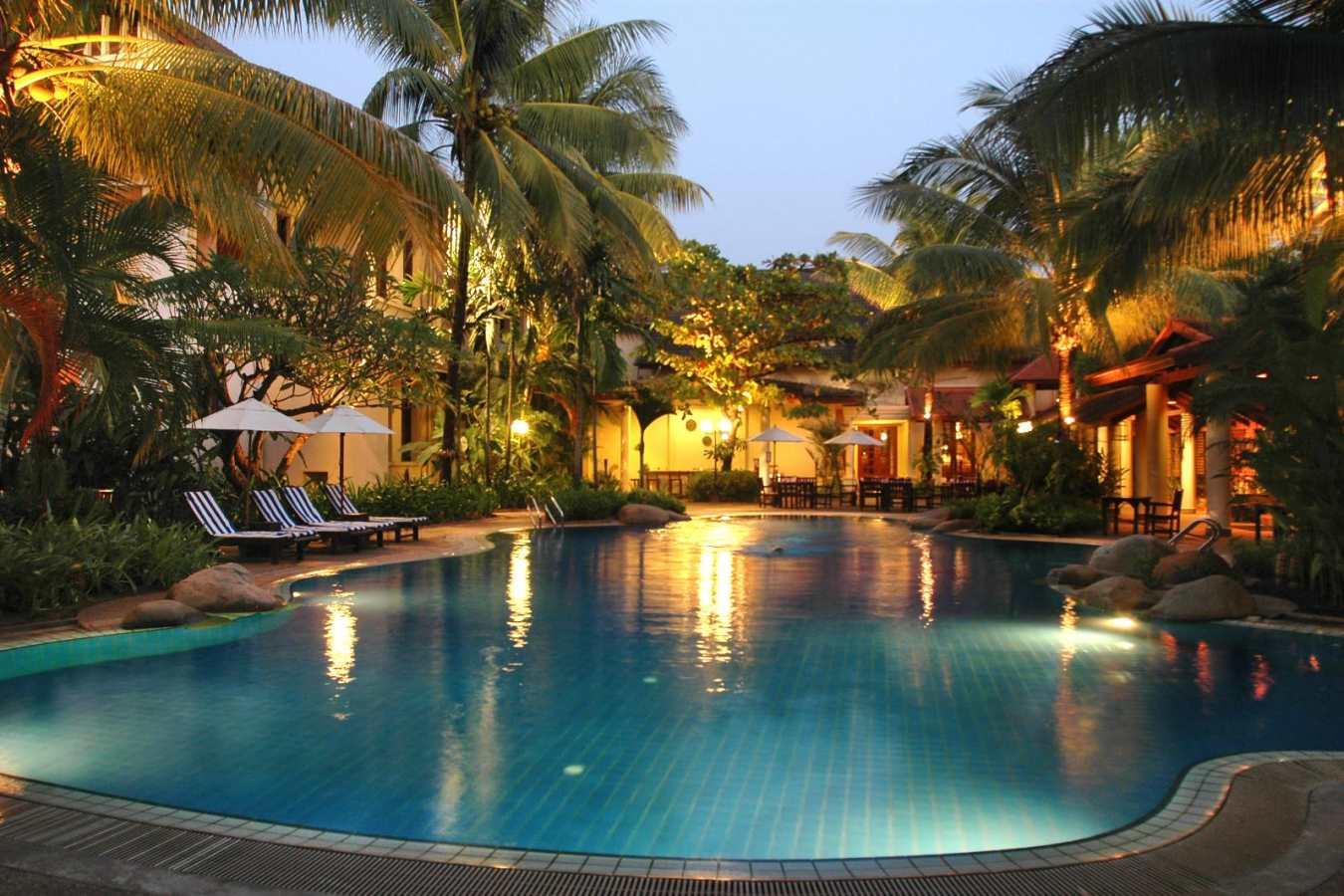 Swimming pool lit up at night - Settha Palace Hotel