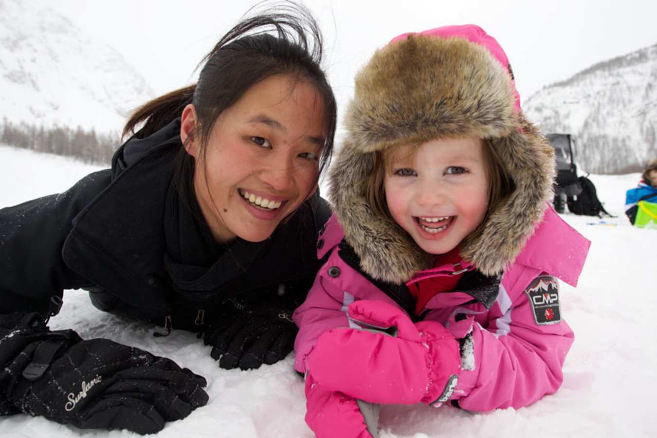 Staff with kid in the snow