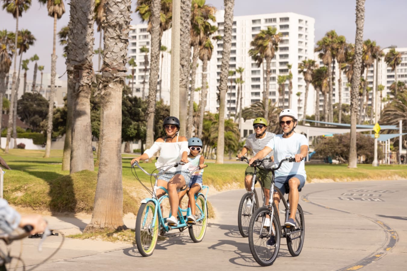 Family biking along Santa Monica beach 
