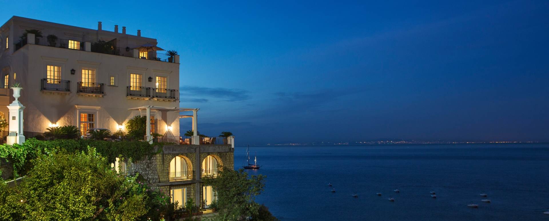Exterior at night - JK Place Capri