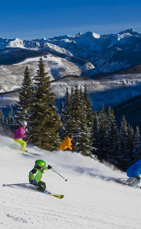 Kids skiing down a mountain