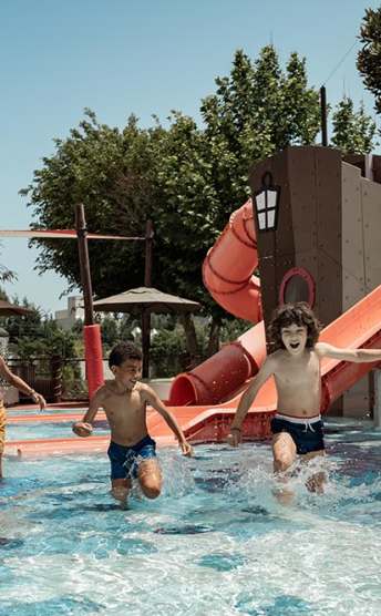 Kids going down a slide in a playground