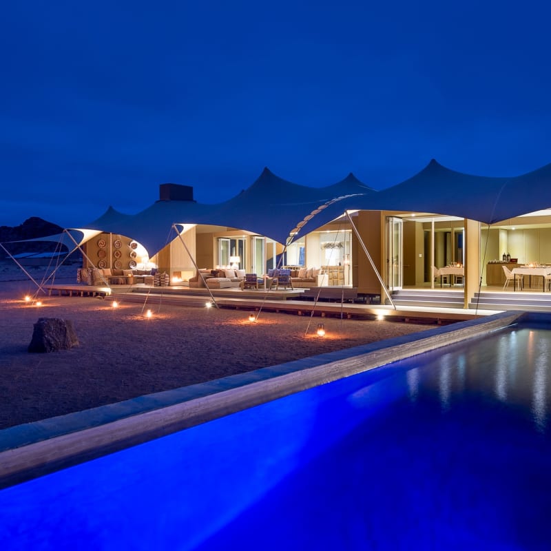 Camp and swimming pool at night   