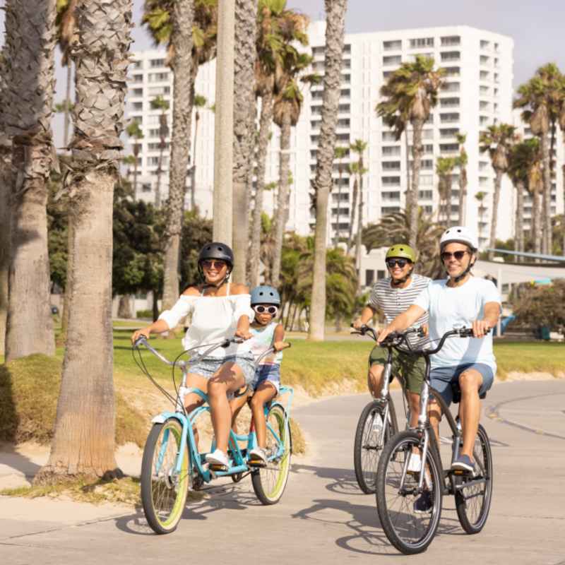 Family biking along Santa Monica beach 