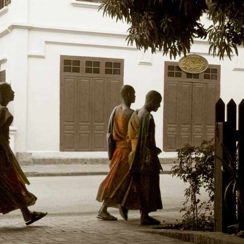 Monks passing by the hotel - 3 Nagas by Alila