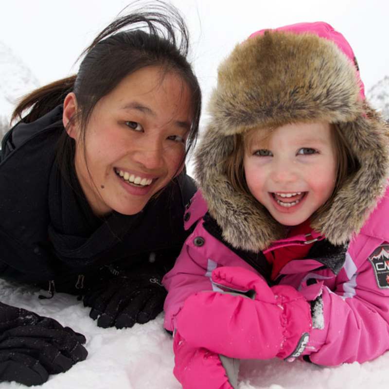 Staff with kid in the snow